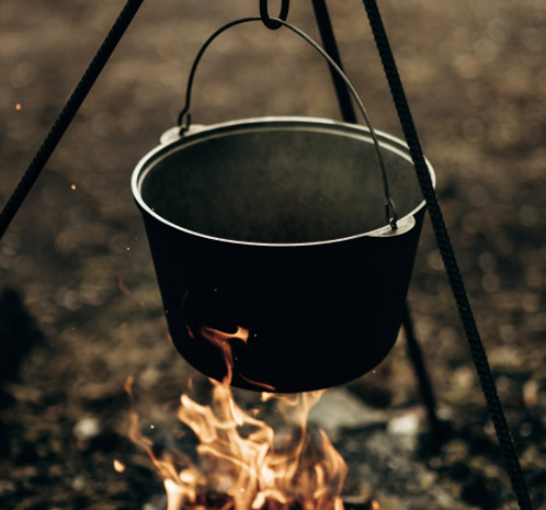 A pot heating over over a campfire